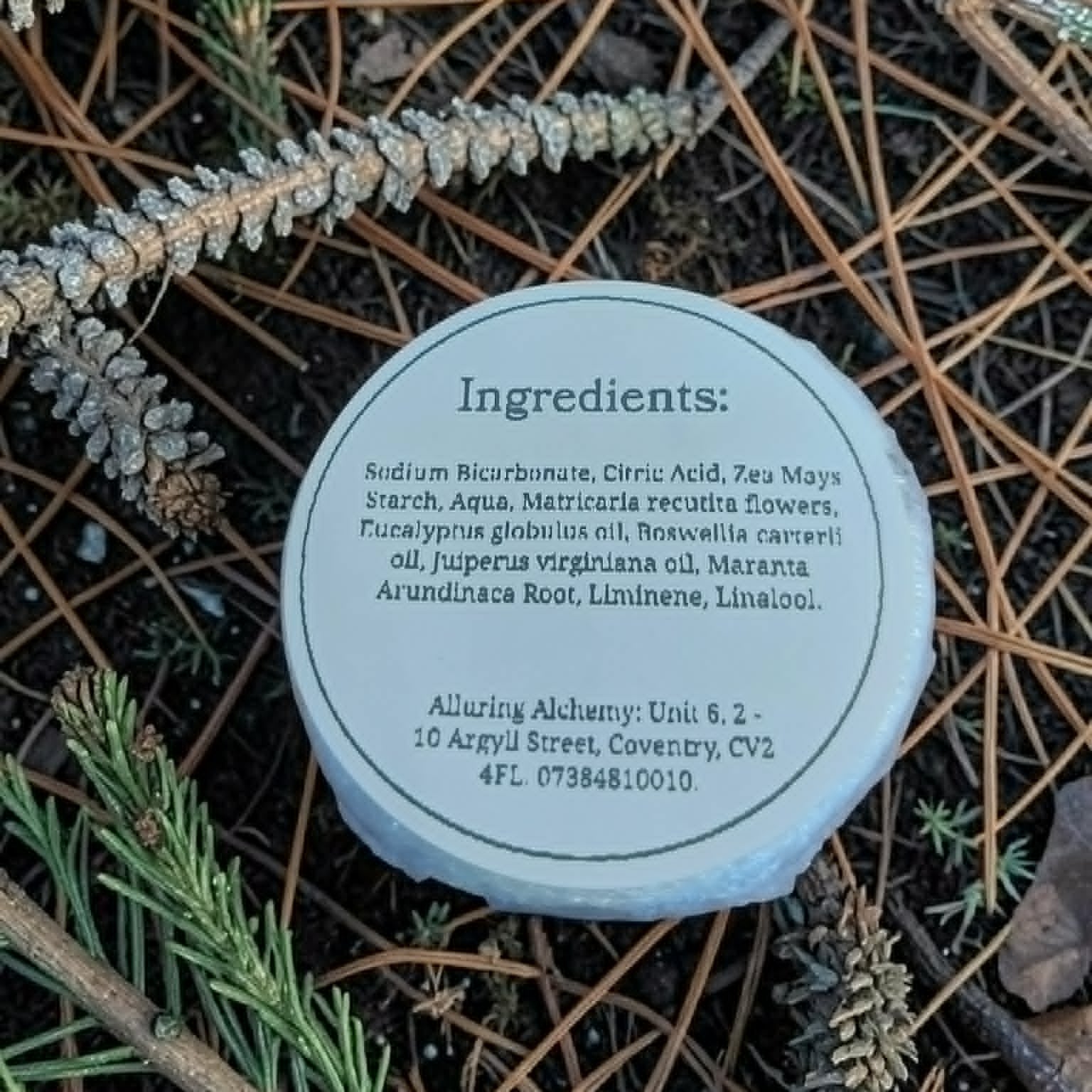 Round container with ingredients list on a natural background