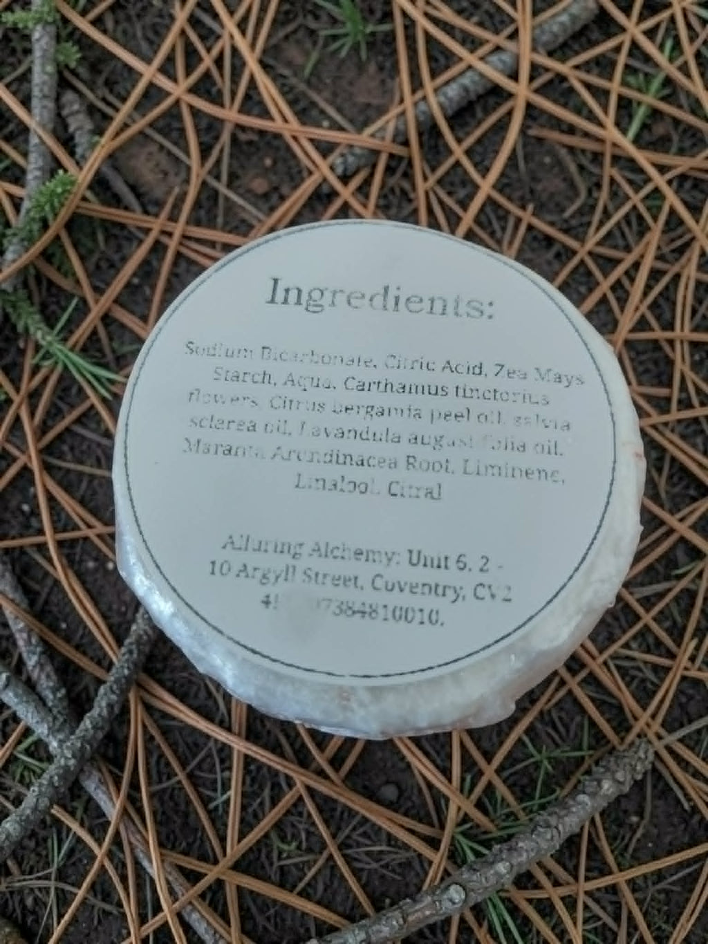 Round container with ingredient list on a textured surface