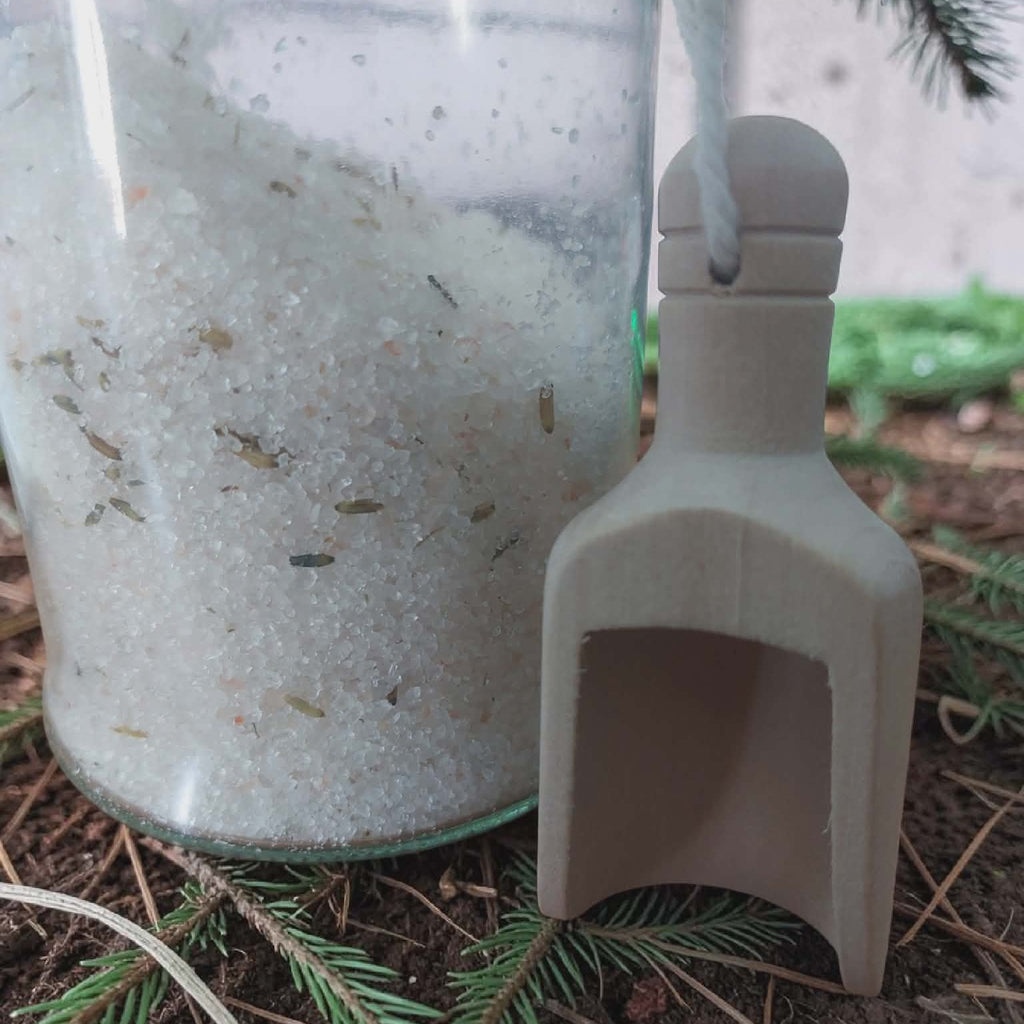 Small container with a scoop on a natural background