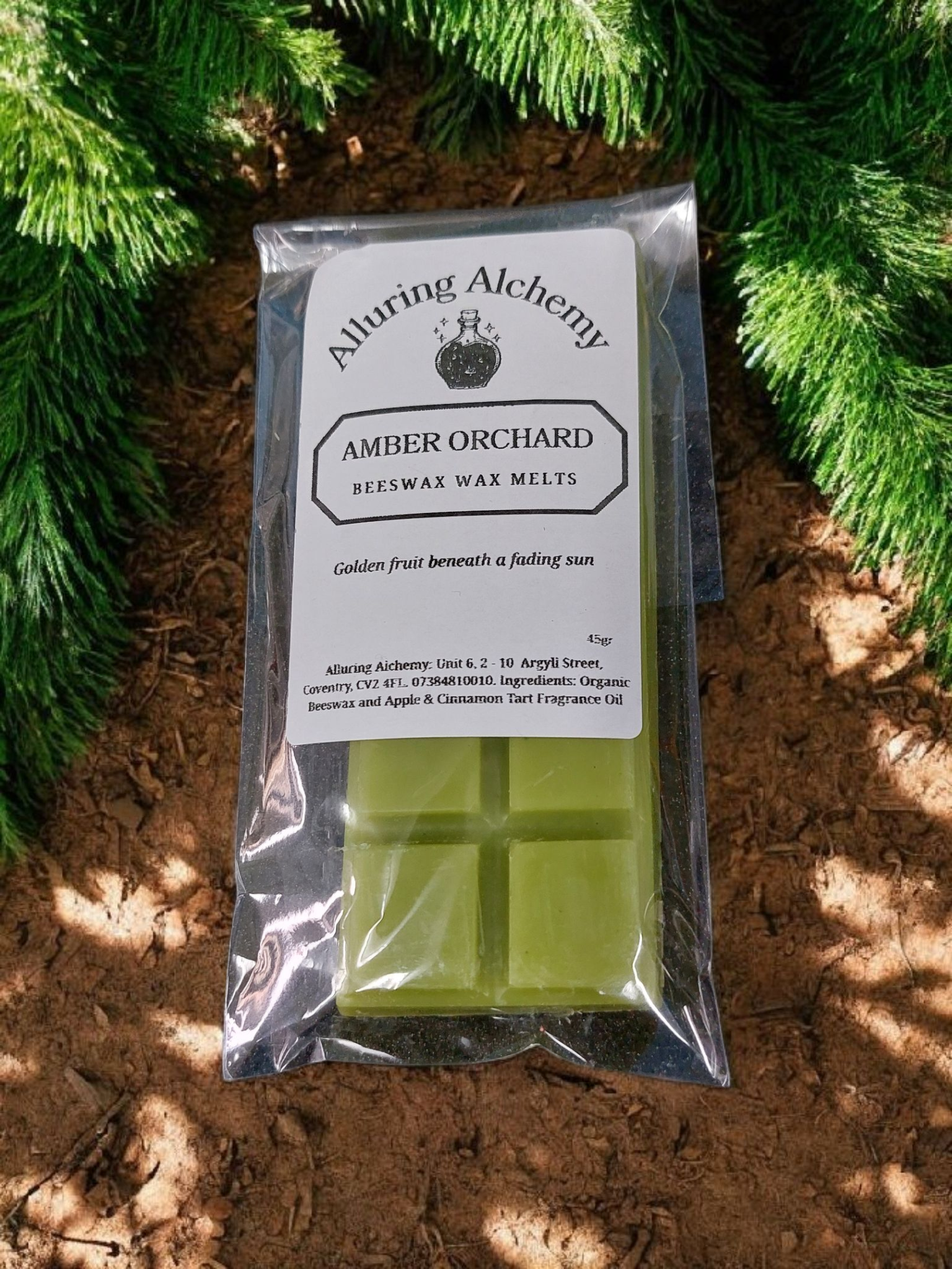 Packaged green wax melts with 'Alturing Alchemy' branding on a natural background