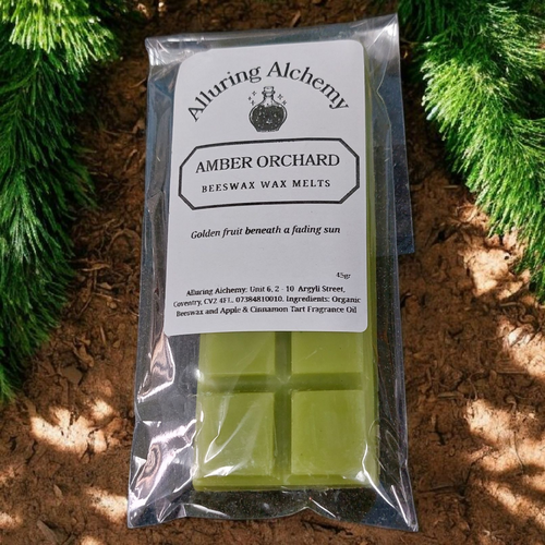 Packaged green wax melts with 'Alturing Alchemy' branding on a natural background