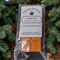 Pack of Alluring Alchemy Lunar Silk Beeswax Wax Melts on a natural background