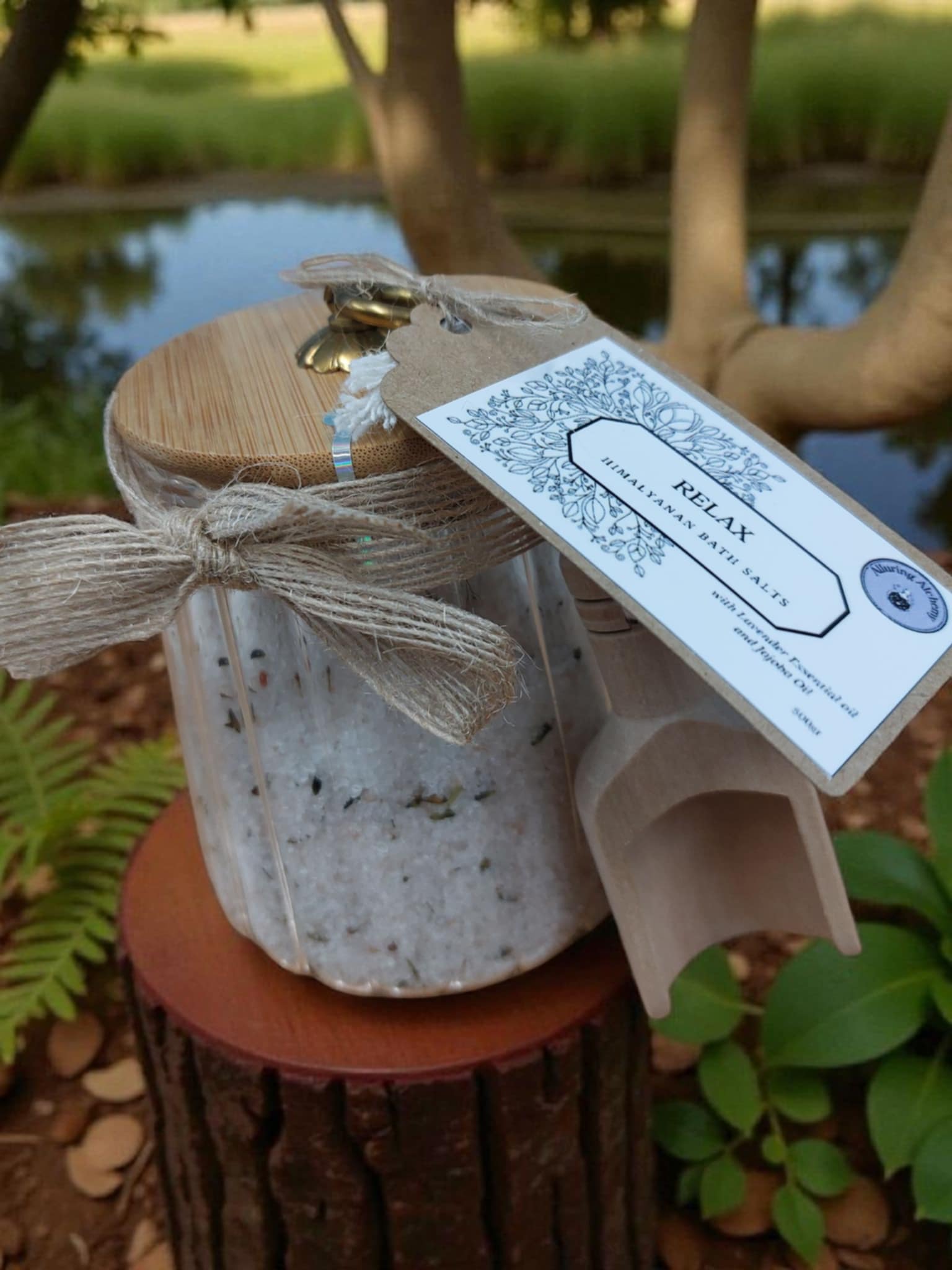 Decorative lantern with a tag labeled 'Relax' in a natural setting with plants and water.