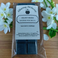 Pack of Alluring Alchemy Velvet Berry wax melts with flowers in the background