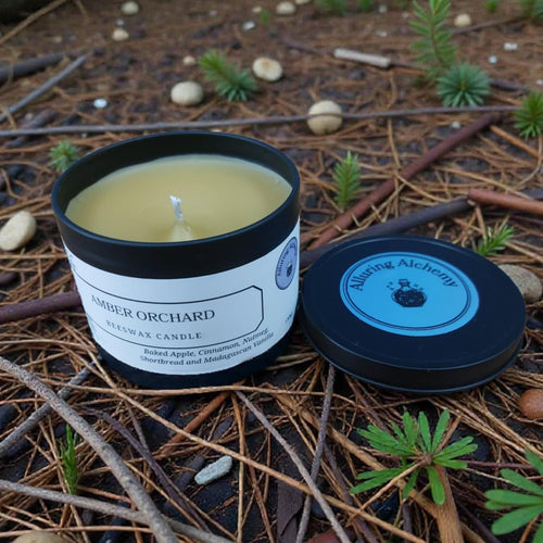Candle with a label on a bed of pine needles and twigs