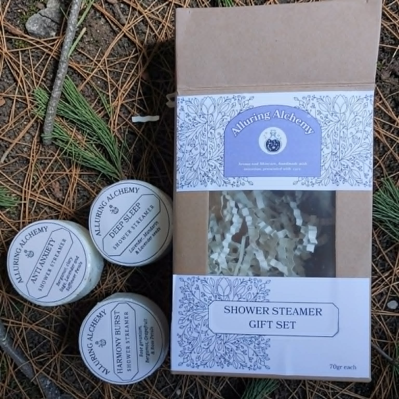 Shower steamer gift set with 'Alluring Alchemy' branding on a natural background.