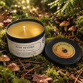 Candle in a tin with a label on a natural background