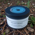 Velvet Berry beeswax candle in a jar with a blue lid on a natural background