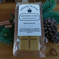 Packaged beeswax wax melts from Alluring Alchemy on a wooden surface with decorative elements.